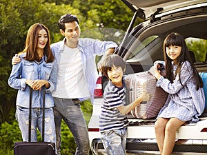 Asian family traveling by car