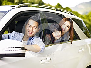 Asian family traveling by car