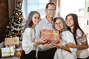 Asian family with two daughter happy gift exchange