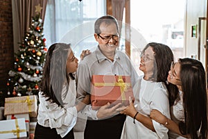 Asian family with two daughter happy gift exchange
