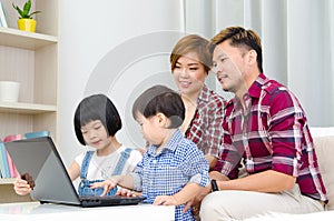 Asian family using laptop