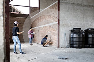 Asian family visiting their new home being built,inspect the house structure,man measuring size of the room on the brick walls,