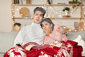 Asian Family Watching Scary Movies On TV Sitting At Home