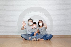 Asian family wearing protectivevent virus and show stop hands signe mask. photo