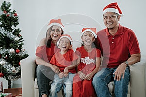 Asian family wearing red during christmas celebration
