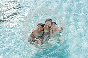 Asian Family, Young Boy Son and 40s Women Mother Having a Good Time Playing and Enjoying in Swimming Pool