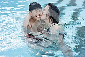 Asian Family, Young Boy Son and 40s Women Mother Having a Good Time Playing and Enjoying in Swimming Pool