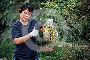 Asian farmer holding Durian is a king of fruit