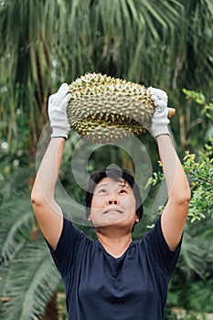 Asian farmer holding Durian is a king of fruit