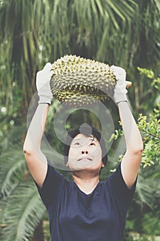 Asian farmer holding Durian is a king of fruit