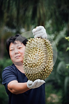 Asian farmer holding Durian is a king of fruit