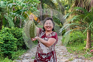 Asian farmer holding Durian is a king of fruit