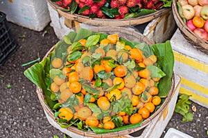 Asian farmer market selling fresh Mandarin in Hoi An, Vietnam. Orange and green colors.