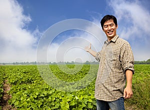 Asian farmer showing his farm