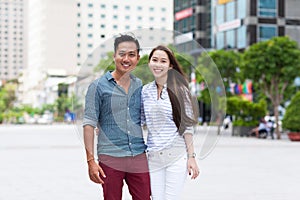 Asian fashion couple smile city street embrace