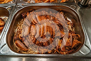 Asian fast food style, fried duck with Chinese noodles at big metal tray