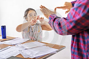 An Asian father is communicating with a deaf daughter