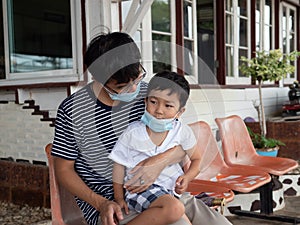 Asian father and cute child boy travelling together with wearing face mask prevent from corona virus or covid-19.