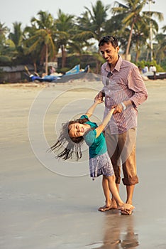 Asian father playing with his daughter