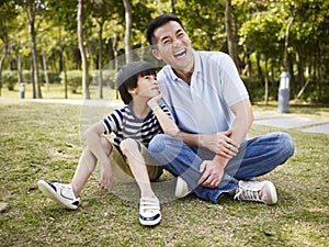 Asian father and son having a conversation