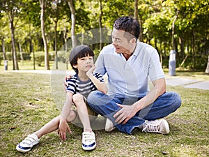 Asian father and son having a conversation