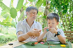 Asian Father and son having fun playing colorful modeling clay, Play dough at home