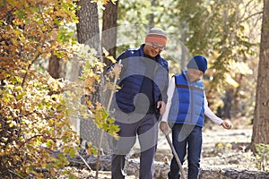 Asian father and son hiking in a forest, close up