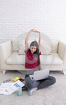 Asian female arm up to stretch oneself after use laptop computer