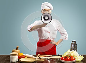 Asian female chef holds a megaphone