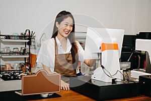 Asian female coffee shop owner in a coffee shop