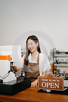 Asian female coffee shop owner in a coffee shop