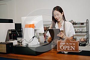 Asian female coffee shop owner in a coffee shop