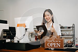 Asian female coffee shop owner in a coffee shop
