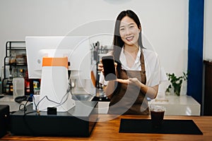 Asian female coffee shop owner in a coffee shop