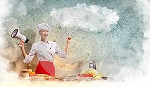 Asian female cook holding megaphone