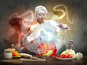 Asian female cooking with magic