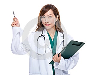 Asian female doctor with clipboard and pen point out