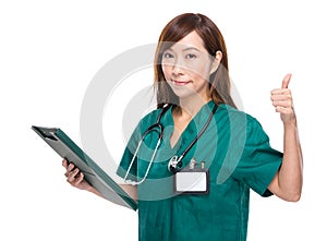 Asian female doctor with clipboard and thumb up