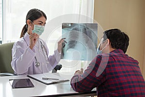 Asian Female Doctor explaining lung x-ray to patient, Healthcare and Medical concept