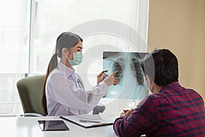 Asian Female Doctor explaining lung x-ray to patient, Healthcare and Medical concept