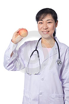 Asian female doctor holding apple with stethoscope