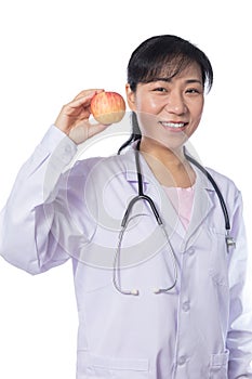 Asian female doctor holding apple with stethoscope