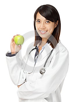 Asian female doctor holding green apple