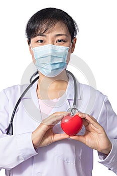 Asian female doctor holding red heart with stethoscope