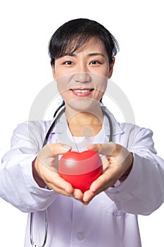 Asian female doctor holding red heart with stethoscope