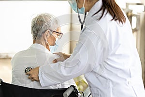 Asian Female doctor listening to sounds from the heart and lungs of senior woman at the back of the body with a stethoscope,health