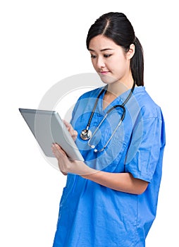 Asian female doctor look at tablet