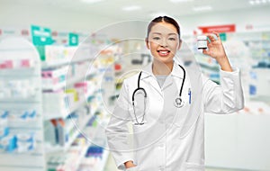 Asian female doctor with medicine at pharmacy