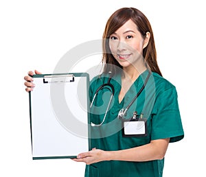 Asian female doctor show clipboard with blank paper