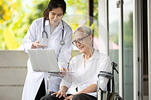 Asian female doctor showing checkup result and explaining to educate medical Information about life planning during consultation